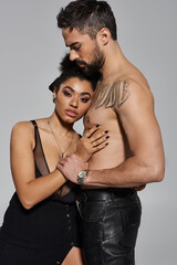 A couple shares an affectionate moment, radiating love and confidence in their presence together.