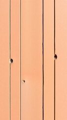 peach-colored wood panel with vertical lines