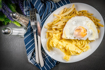 Fried egg served with boiled potatoes and yellow beans.