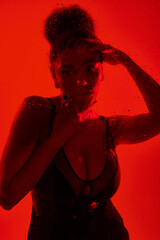 pretty woman in dress surrounded by red lights.