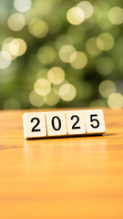 Naklejka premium year 2025 spelled out with wooden blocks