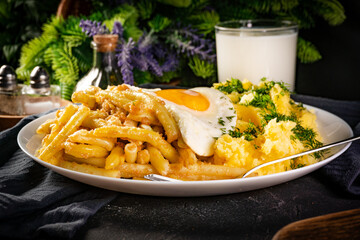 Fried eggs with boiled potatoes and yellow string beans.