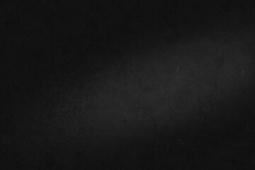 Black concrete texture. Dark concrete surface background with illuminated area