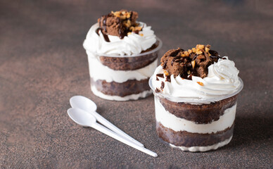 Dessert of chocolate sponge cake, whipped cream and nuts