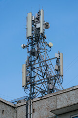 Antenna on the roof of the house with many radio transmitters. Antennas of communication in the city.