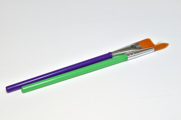 Two thin brushes for painting with watercolors at school.