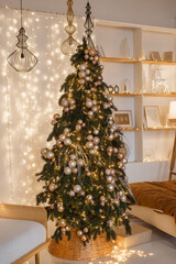 Christmas tree in the interior of the bedroom decorated for the New Year holidays. Cozy interior in bronze shades. Background for New Year wallpapers and postcards.