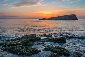 Dramatic sunset sea, clouds and beautiful orange sky, sandy beach and calm waves, Beauty landscape view of sea coast, Closeup sea beach,Calm tranquil relax summer tropical in mediterranean sea Algeria