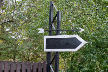 landscape with signpost arros showing course, left and right direction to choose