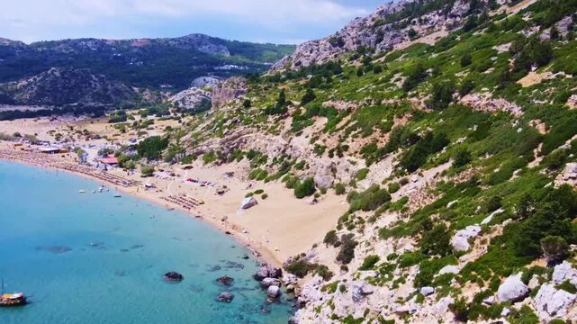 Aerial view of sandy beach of Tsambika with tourists swimming in beautiful clear sea water. Greece Europe