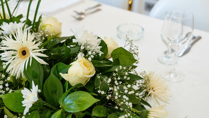 Beautiful flowers decorated on the table. Tables set for an event party or wedding reception. luxury elegant table setting dinner in a restaurant.