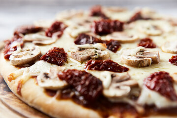 Pizza with mozzarella cheese and marinated tomatoes. Close up.