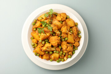MIX VEGETABLE CURRY- indian recipe, mixed veg containing  cauliflower, green peas and  potatoes with traditional masala and curry, red hot and spicy served in a copper bowl