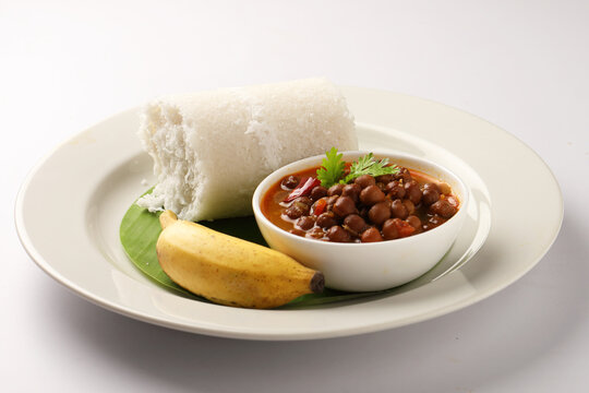 Puttu or Raw rice puttu with chana curry or kadala curry-Kerala special breakfast items made using raw rice flour, an ideal combination with banana