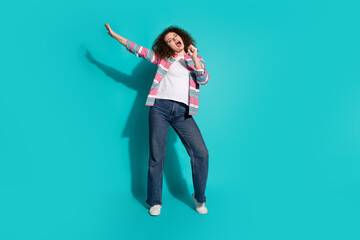 Photo portrait of curly hair beautiful charming young brunette lady singing her favorite song karaoke isolated on aquamarine color background