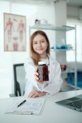 A woman doctor holding a bottle of medicine