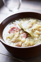 Cabbage soup on wooden background. Close up.