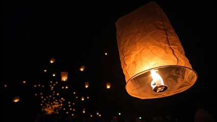 A glowing ember of smoke remains suspended in the blackness, orange light, smoky ambiance