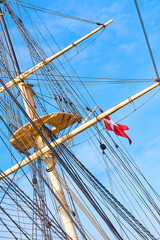 Blue sky, flag and travel with mast of ship outdoor in nature from below for Danish heritage....