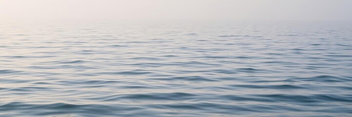 Naklejka premium A serene sea ripple water scene with a gentle morning fog rolling in across the waves, oceanic, weather