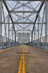 Old Buchanan Dam highway iron truss bridge, converted to a pedestrian bridge with swings installed for those photo ops.