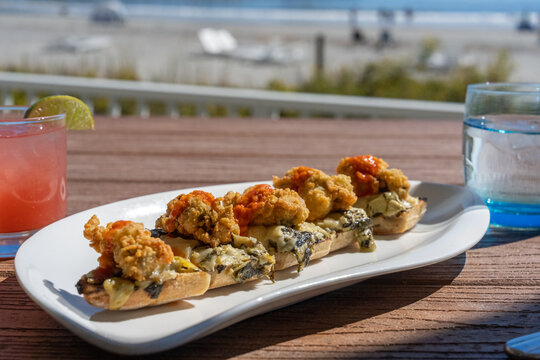 Fried oysters on the shells at the beach 