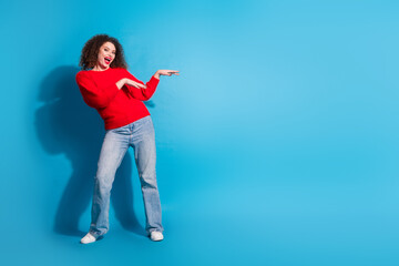 Full size photo of pretty young girl dancing have fun wear trendy red outfit isolated on blue color background