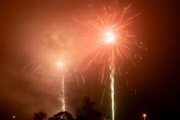 Colorful fireworks on foggy night sky, Corby, U.K., Bonfire celebration