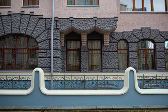 Building facade with dark rusticated stone and arched windows