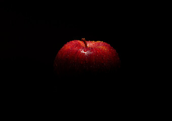 Close-up of a fresh apple Water splashes
