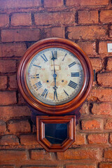 Fototapeta premium old wall clock in a brick wall