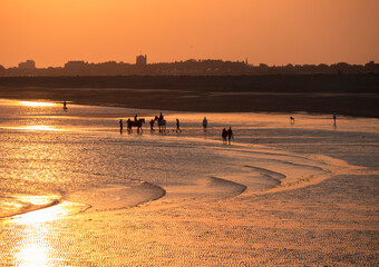 Beach at south end of Hayling island is turned golden by sunset