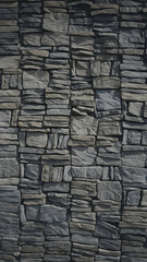 Fototapeta premium Dark stone wall with tightly packed irregularly shaped stones Vertical Mobile Wallpaper