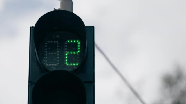 close up city landscape in sky designation signs for movement of cars around the city sign of the crossing zone for people green traffic light timer