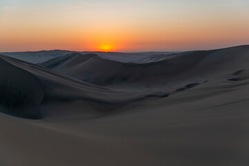 Nazca desert sunset with sand dunes between Huacachina and Ica, Peru.