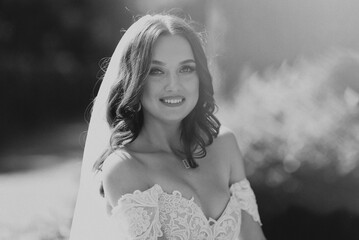 White bride in wedding dress with veil smiling