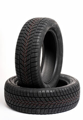 Two winter tires standing on white background in studio