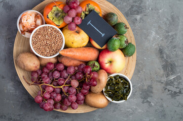 Example of a range of food products containing iodine, I. The concept of a proper balanced diet. On a dark background, top view, horizontal.