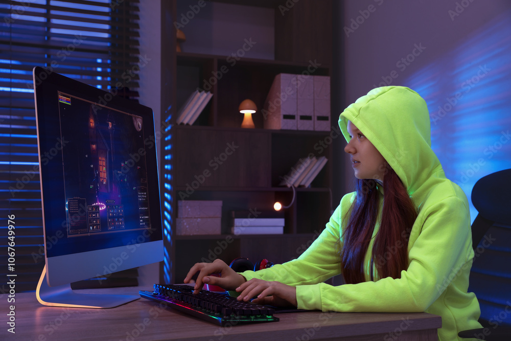 Wall mural Girl playing video game with keyboard at table indoors