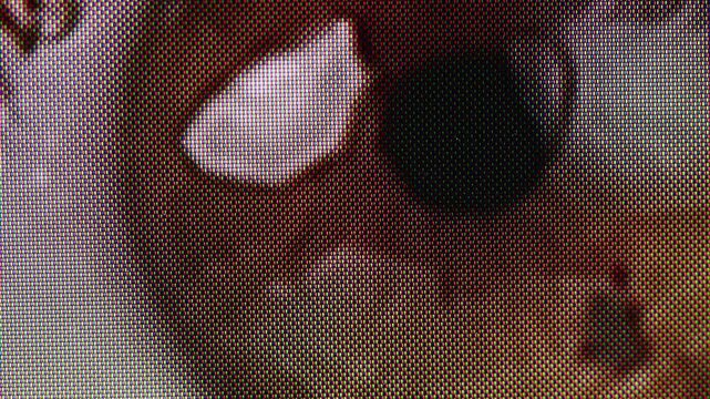Close-up of green eyed woman with no make-up on face macro vhs retro tape pixel content. Blinking eye with long lashes. Beauty skin care make-up routine