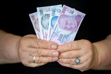 Turkish Lira in Hands of Elderly Retired Woman. Farmer woman and Turkish lira in hand