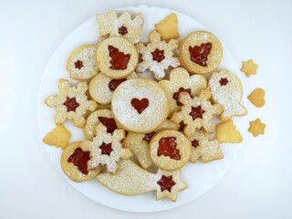 Linzer cookies on a white plate and white background