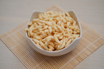 telur gabus sticks in a bowl on wooden table