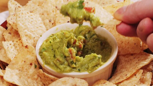 Nachos with Guacamole dip, traditional mexican food in restaurant for nachos, close up of avocado plate for vegetarians.