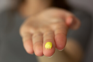 Closeup of a woman using a retinol cream.
