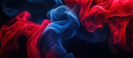 Fototapeta premium Abstract red and blue smoke swirls on a dark background.