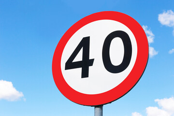 Speed limit sign. Traffic sign isolated on blue sky. 40 kmph background. Safety on the road with empty copy space.