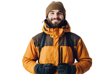 Man wearing an orange and brown jacket with gloves stands smiling indoors during winter