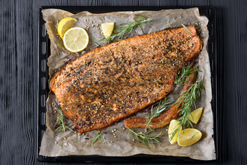 baked salmon fillet on baking tray, top view