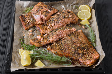baked salmon fillet on baking tray, top view